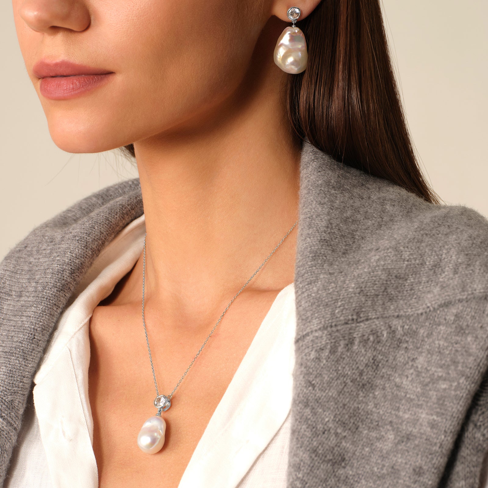 Baroque freshwater pearl and round cubic zirconia pendant necklace in white gold color worn on model