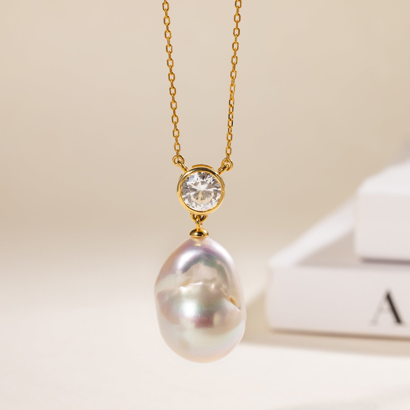 Baroque freshwater pearl and round cubic zirconia pendant necklace in yellow gold color display view