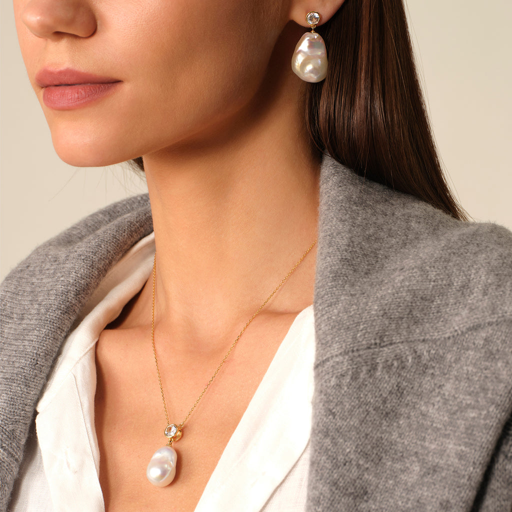 Baroque freshwater pearl and round cubic zirconia pendant necklace in yellow gold color worn on model