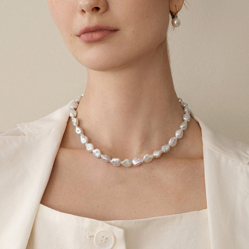 Model wearing baroque iridescent freshwater pearl strand necklace close view