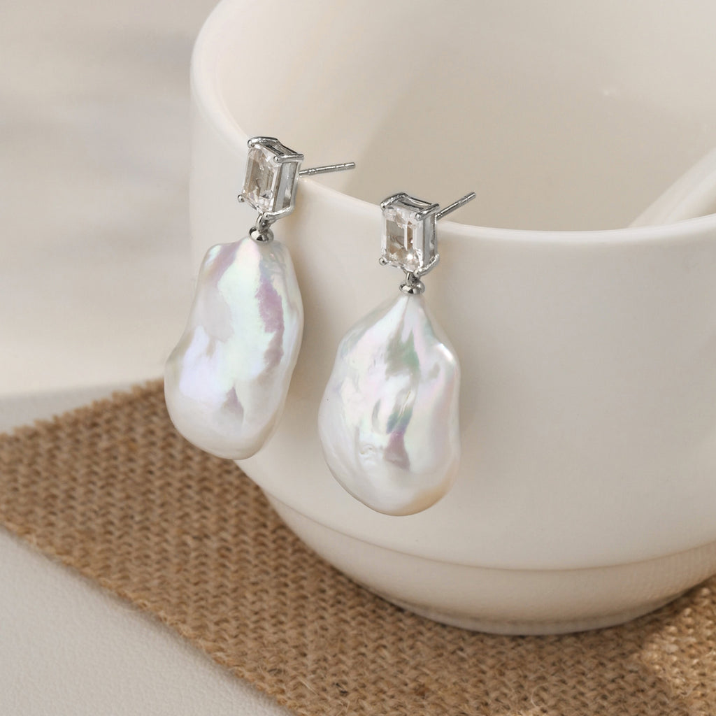 Model wearing baroque freshwater pearl rectangular cubic zirconia stud earrings in white gold color