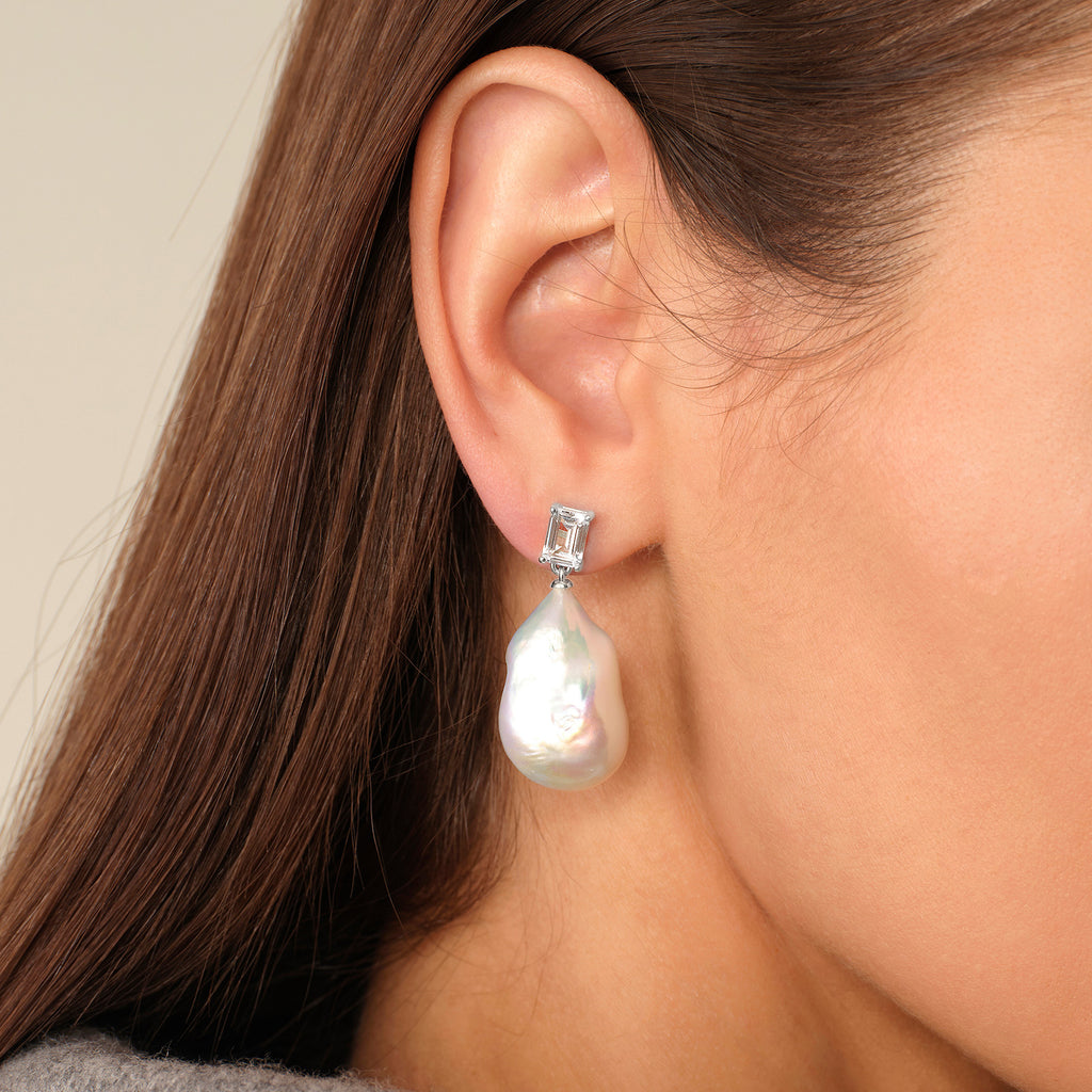 Close-up of model wearing baroque freshwater pearl rectangular cubic zirconia stud earrings in white gold color