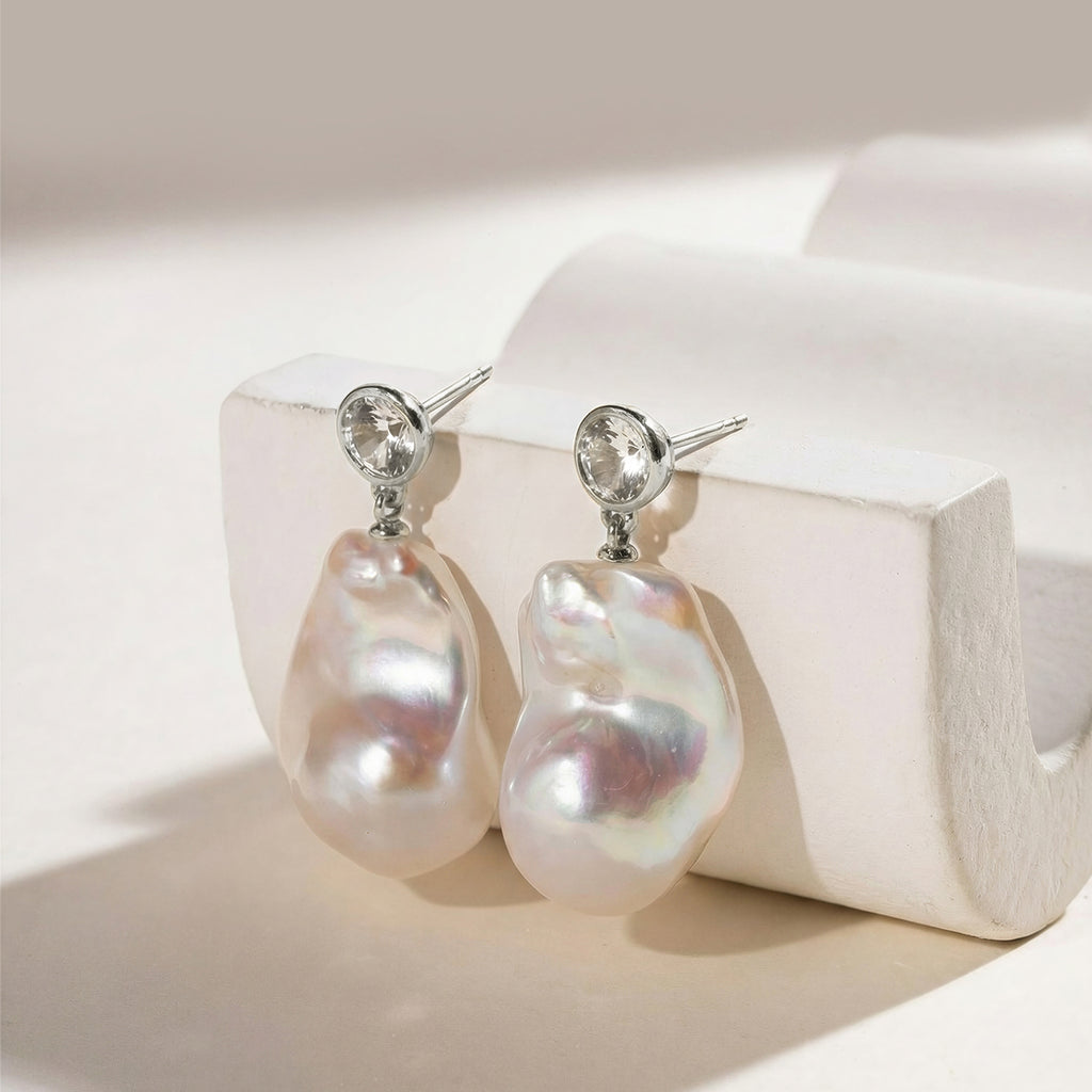Detail view of baroque freshwater pearl round cubic zirconia stud earrings in white gold color