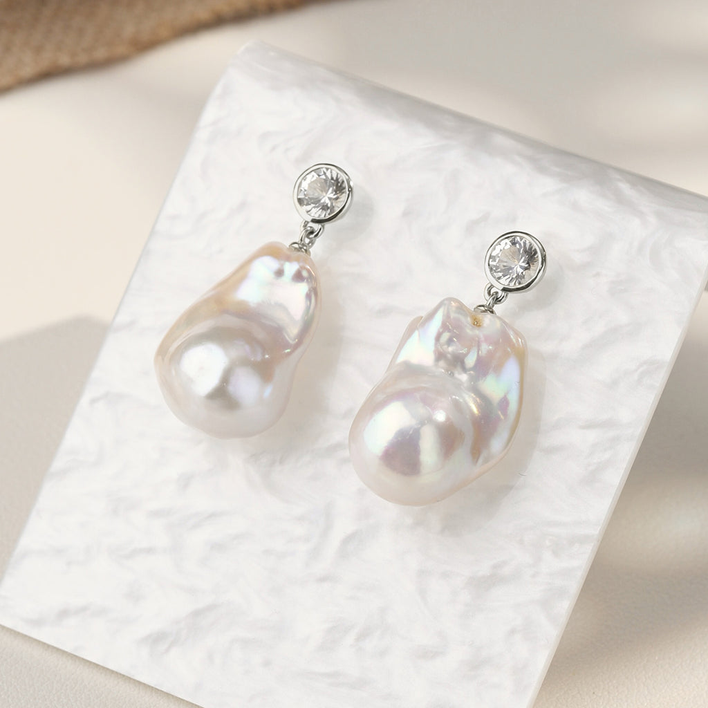 Close-up of baroque freshwater pearl round cubic zirconia stud earrings in white gold color