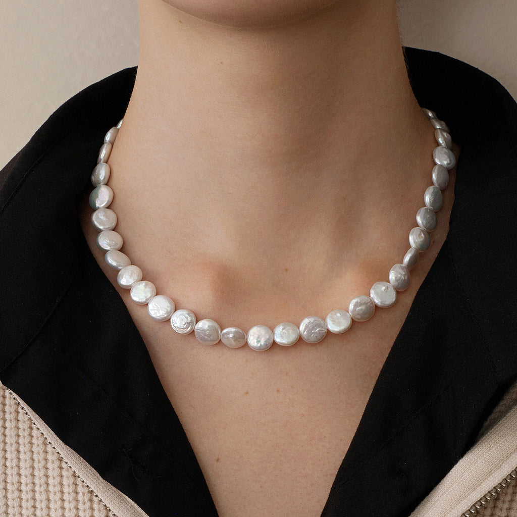 Model wearing button iridescent freshwater pearl strand necklace close view