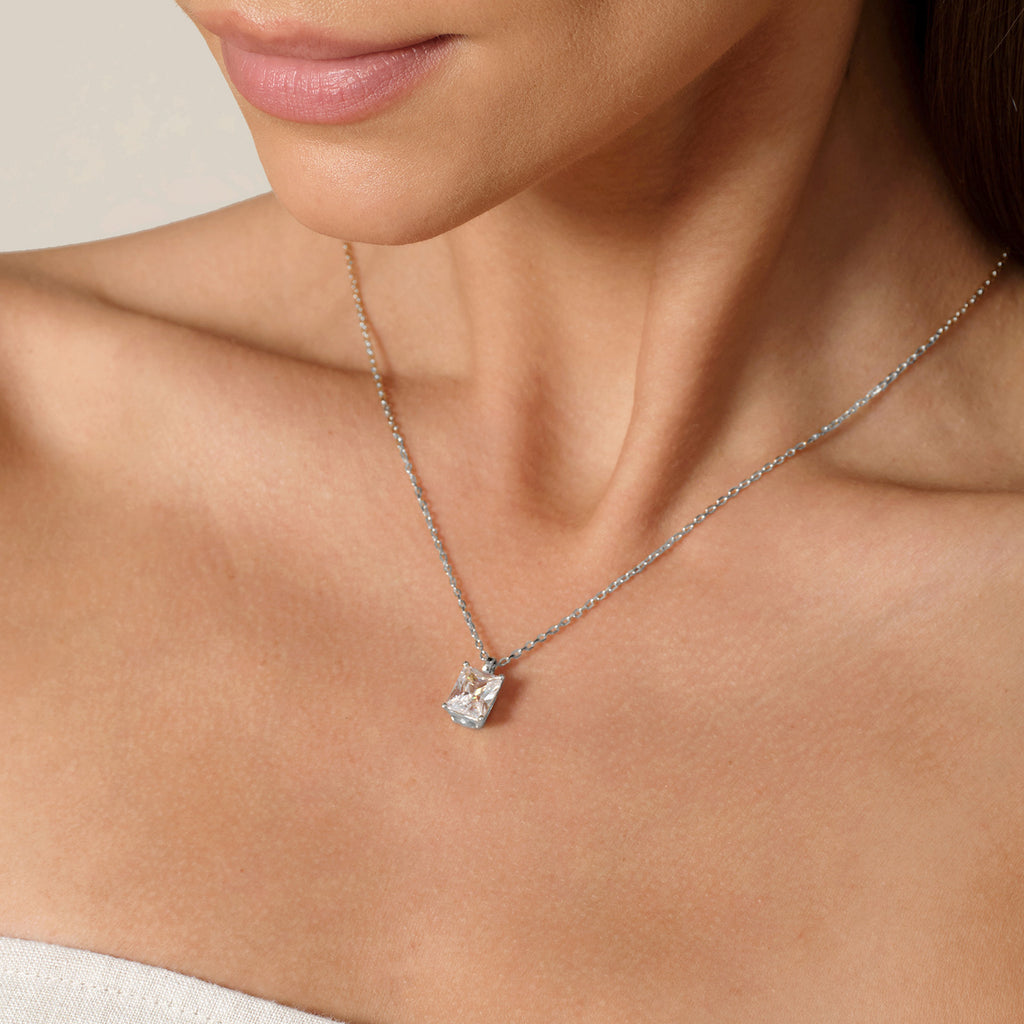 Model wearing emerald-cut cubic zirconia pendant necklace in white gold color, lifestyle view