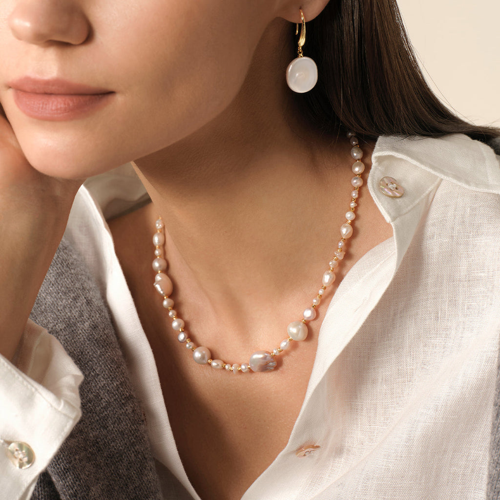 Model wearing mixed freshwater baroque pearl strand necklace, additional view