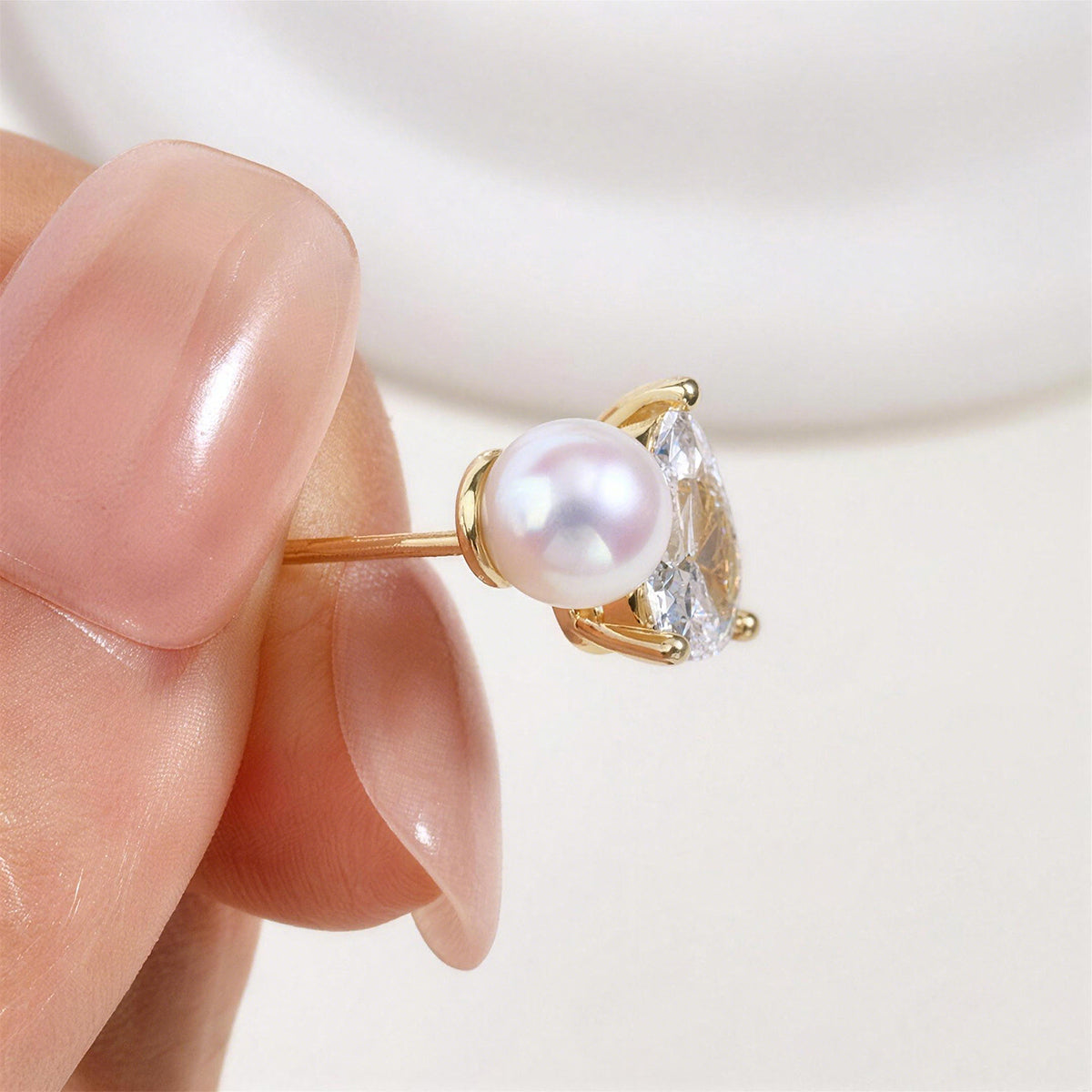 Freshwater pearl and pear-shaped cubic zirconia stud earrings in yellow gold color display view