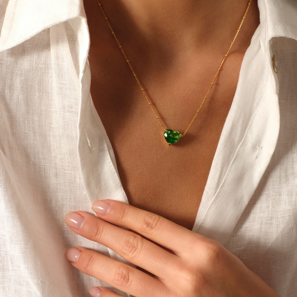 Close-up of a model wearing a green heart cubic zirconia pendant necklace