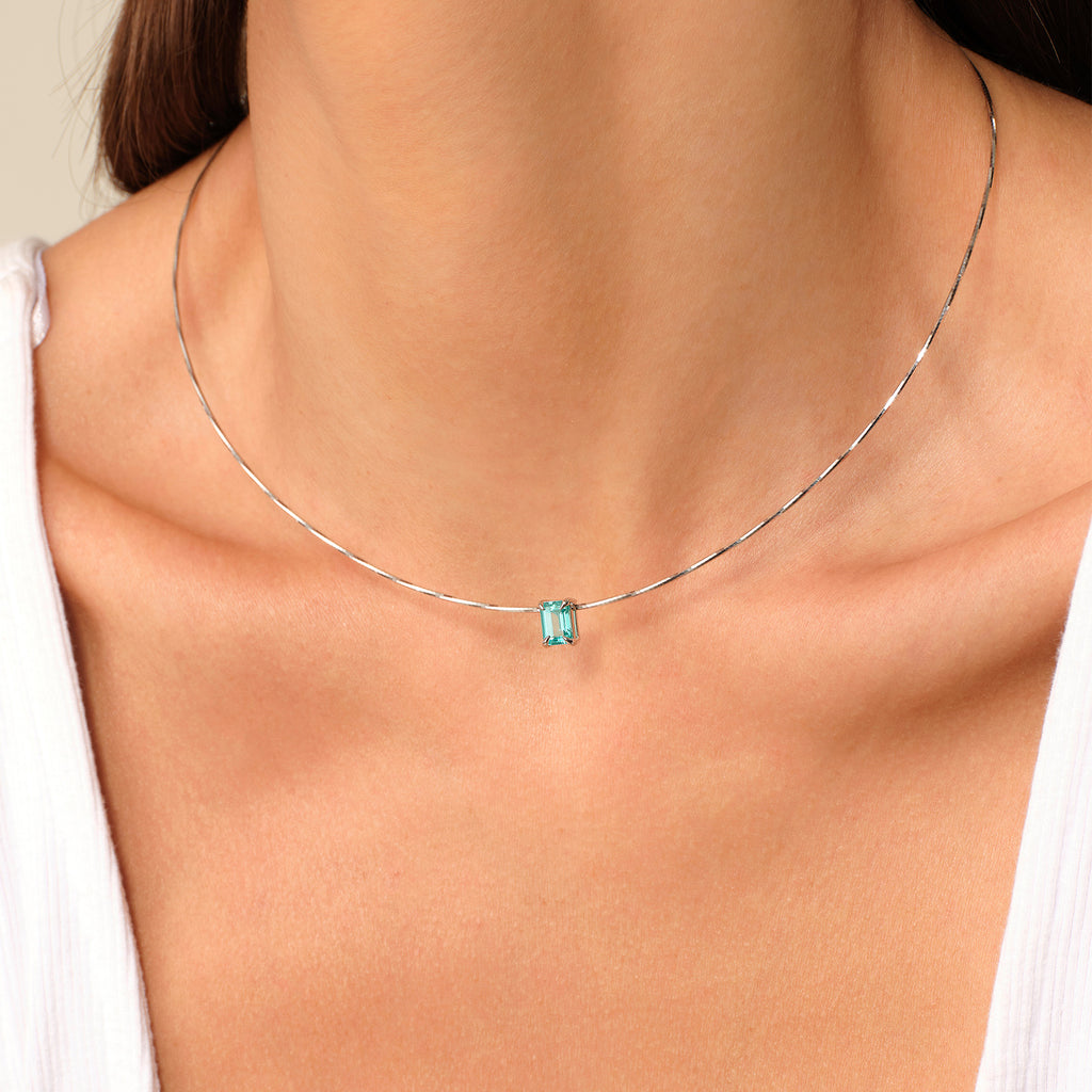Model wearing a lab-created Paraiba garnet rectangular pendant necklace