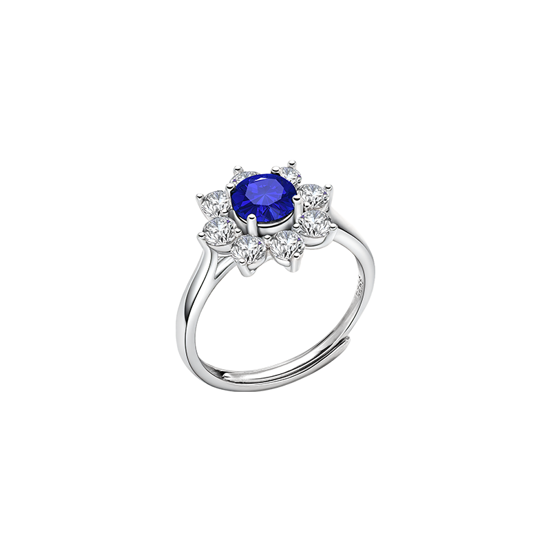 Round blue lab-created sapphire floral halo ring in sterling silver, angled view