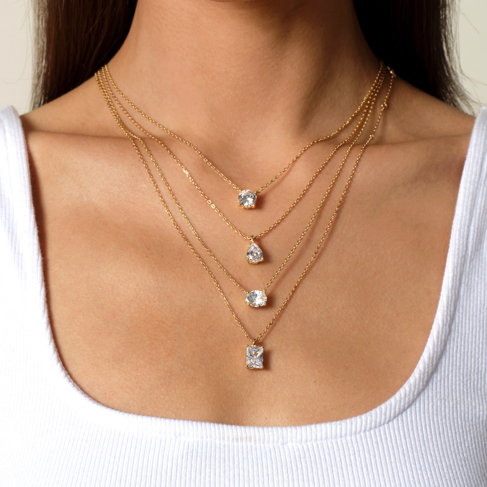 Oval cubic zirconia pendant necklace in yellow gold color layering view