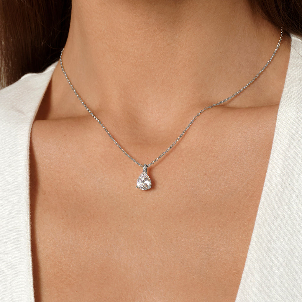 Model wearing pear-shaped cubic zirconia pendant necklace in white gold color