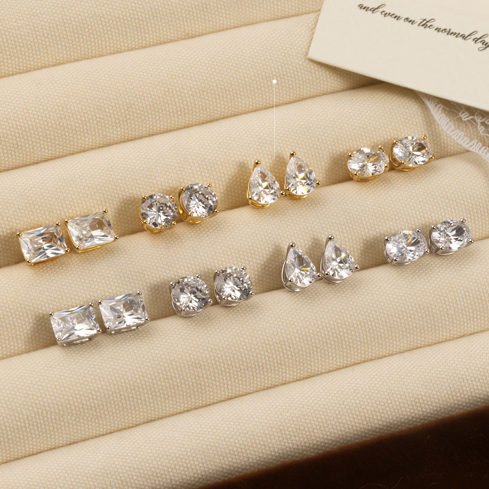 Pear-shaped cubic zirconia stud earrings in gold color display tray view