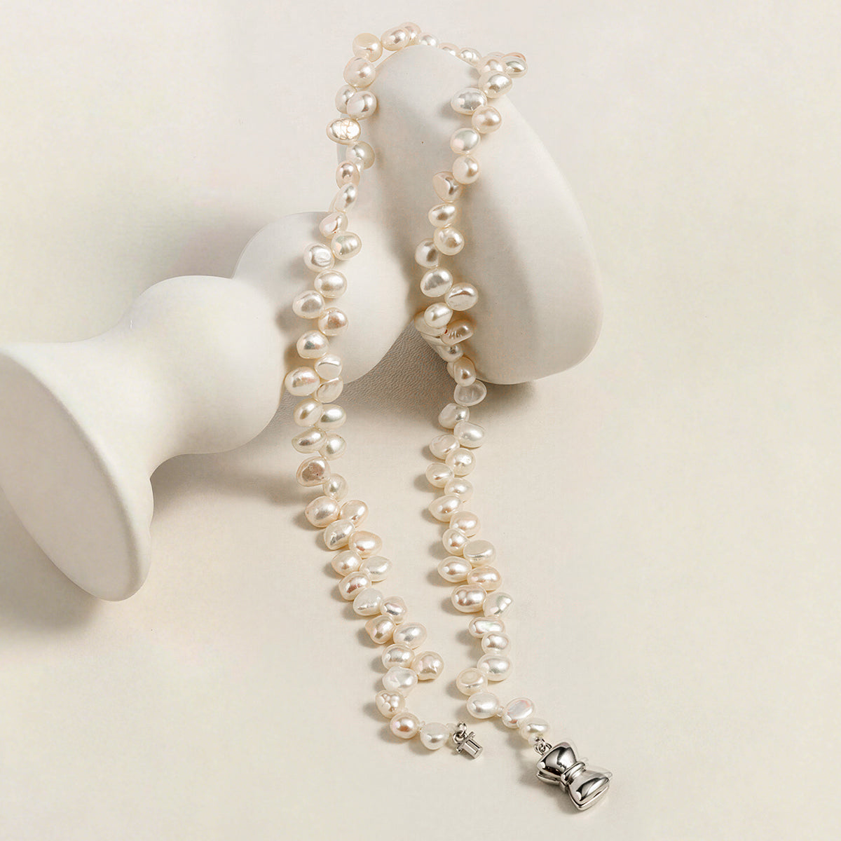 Detail view of the freshwater pearl strand necklace with bow clasp