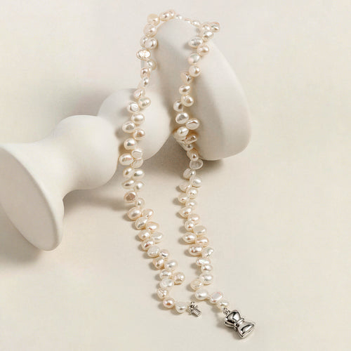 Detail view of the freshwater pearl strand necklace with bow clasp