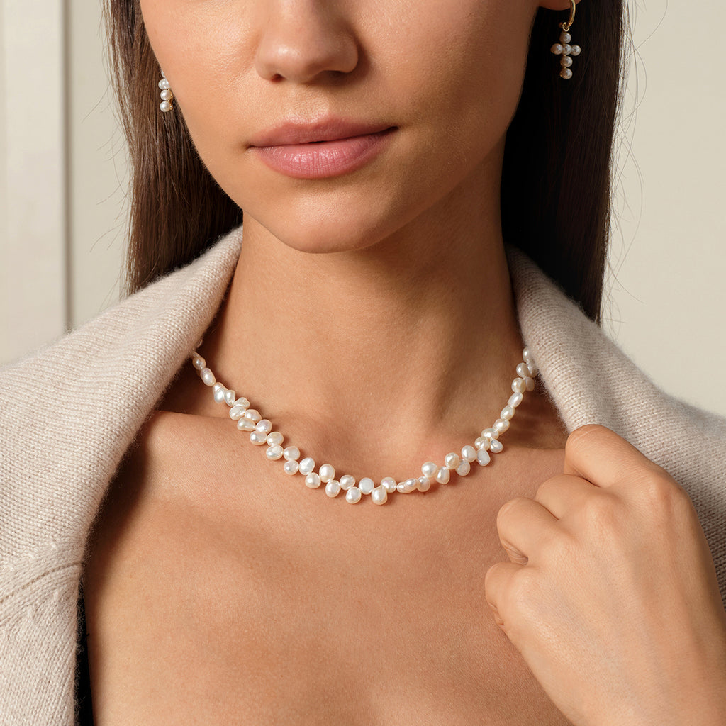 Freshwater pearl strand necklace worn with the bow clasp detail visible
