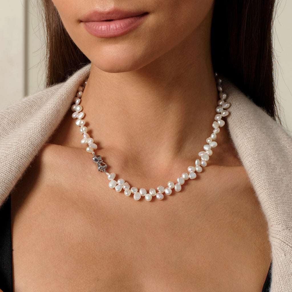 Close worn view of the freshwater pearl strand necklace at the neckline