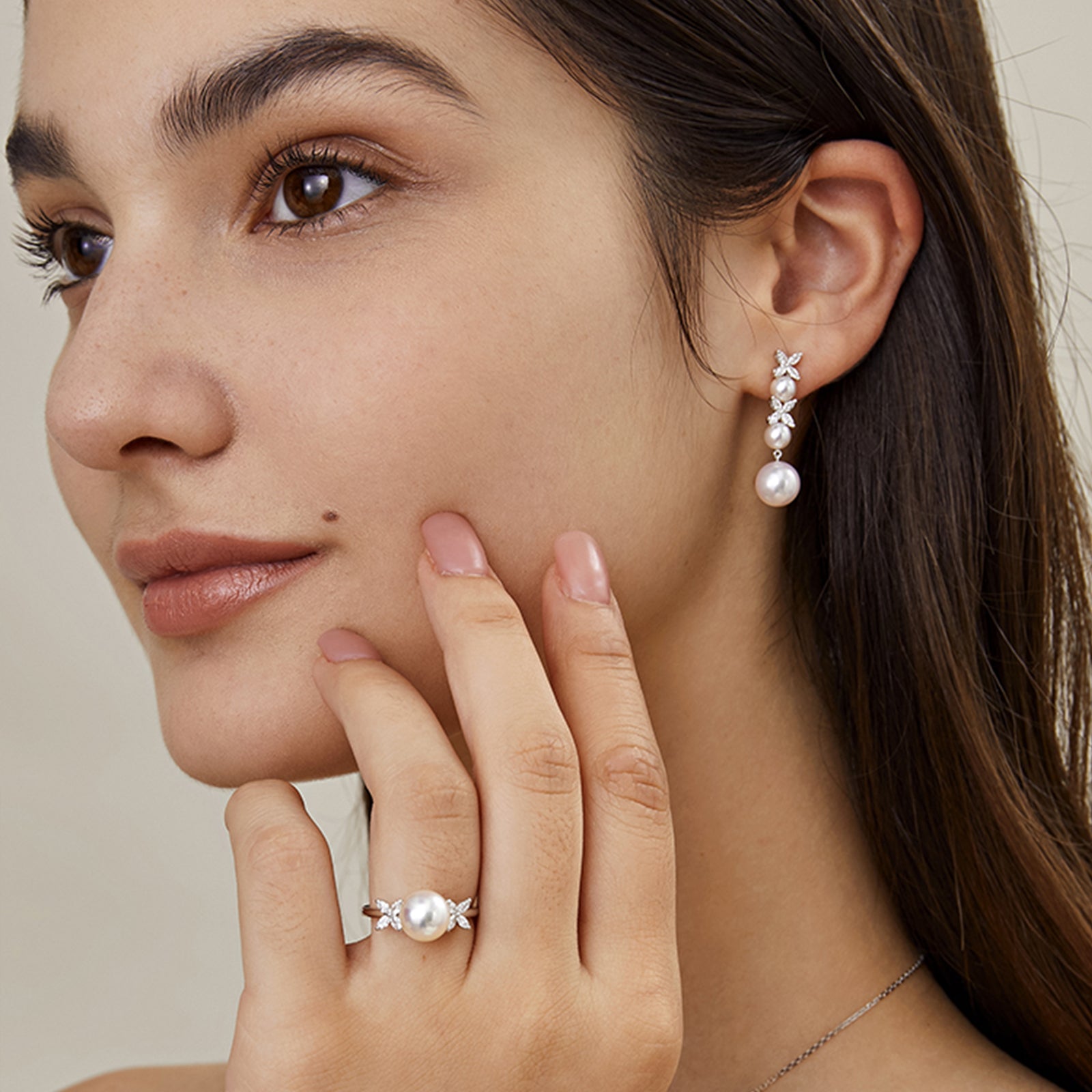 Side view of freshwater pearl cubic zirconia dangle earrings on the ear