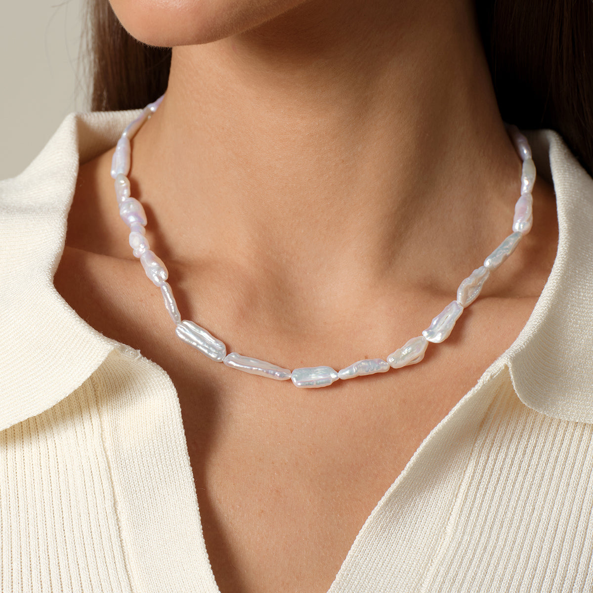 Close worn detail of the baroque freshwater pearl strand necklace