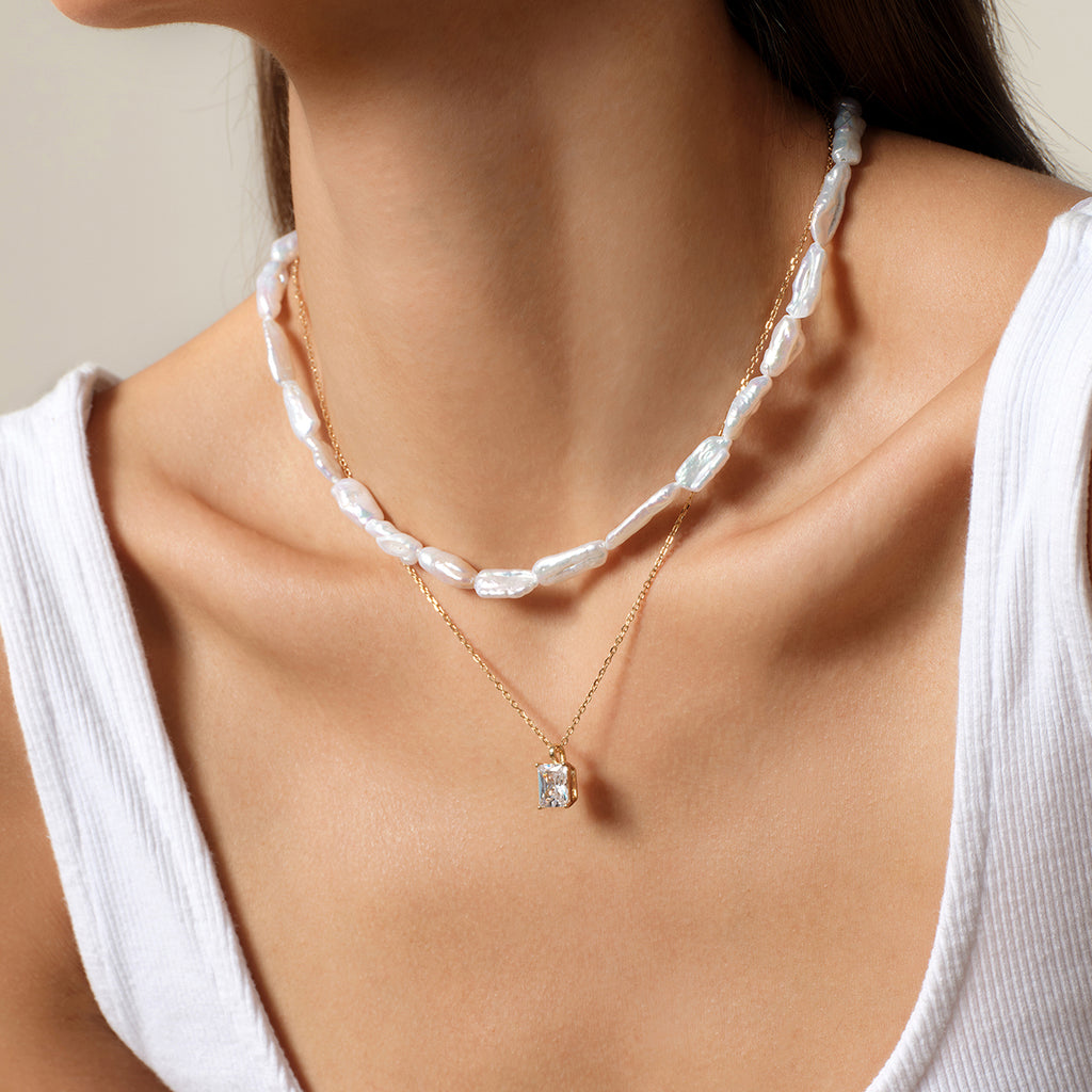 Side worn view of a baroque freshwater pearl strand necklace