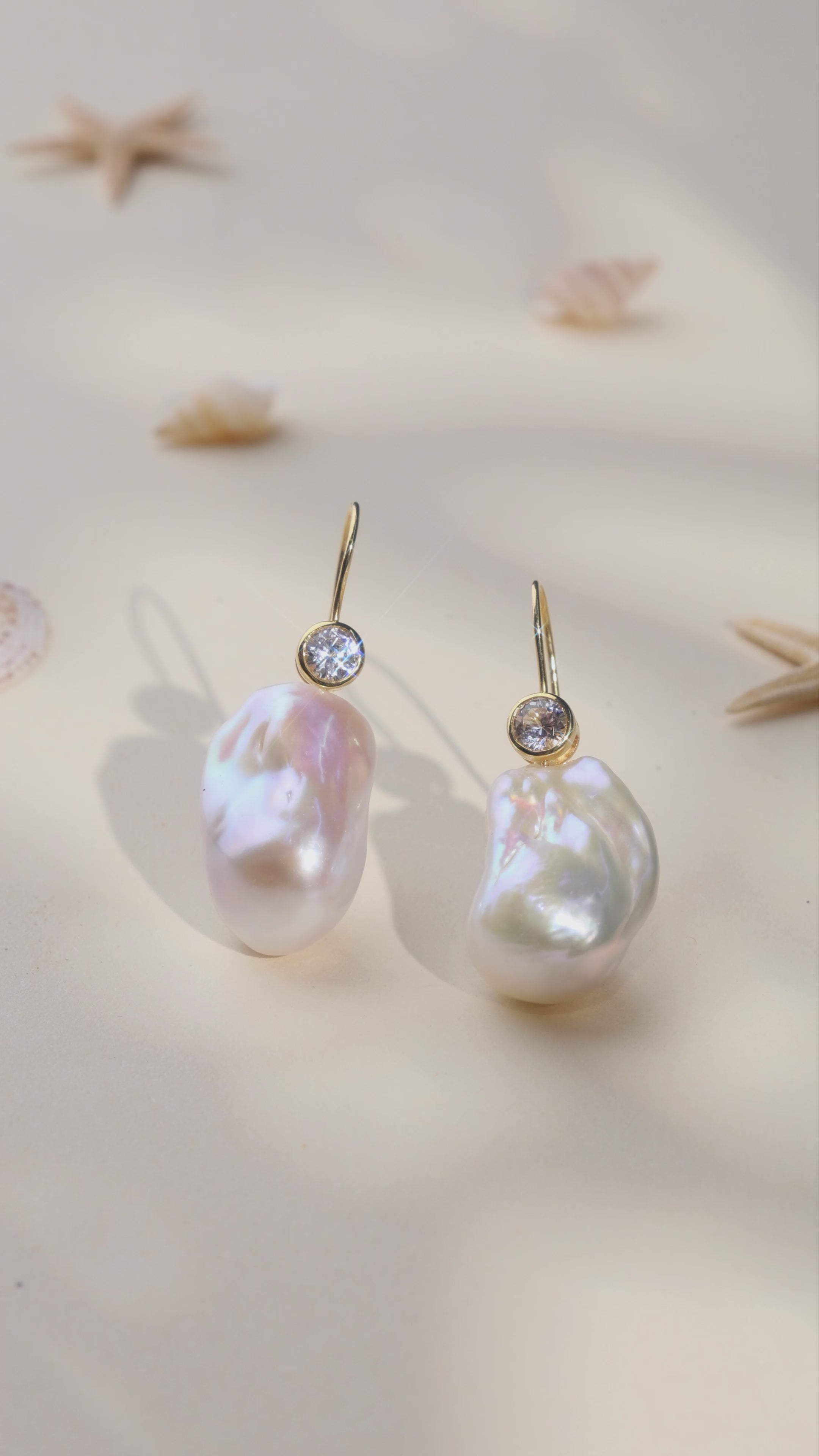 Product video for baroque freshwater pearl and round cubic zirconia hook earrings in yellow gold color