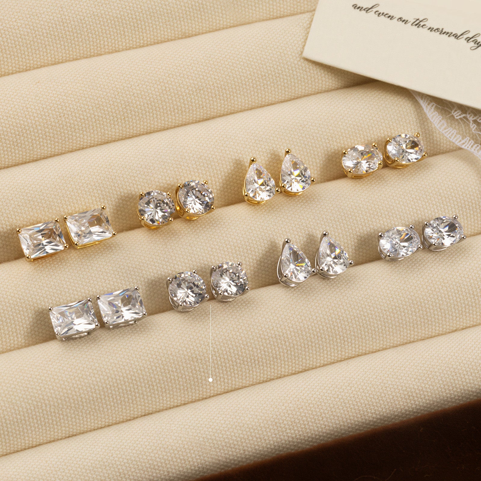 Round cubic zirconia stud earrings in silver color display tray view